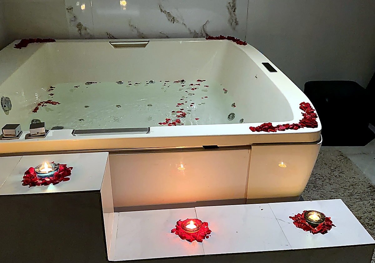 Private jacuzzi with rose petals and candles at Vaayu Wellness Spa